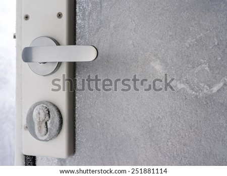 Glass doors with padlock covered with hoarfrost ice crystals in frosty day