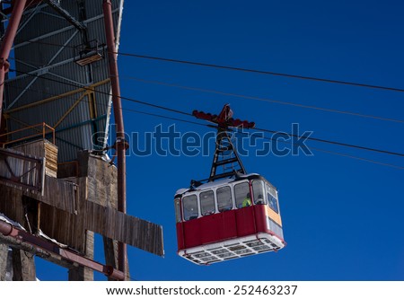 Old pendulum cableway for transport large numbers of people in mountains Caucasus on background blue sky