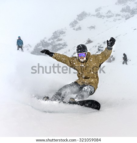 Freerider snowboarder moving down in snow powder