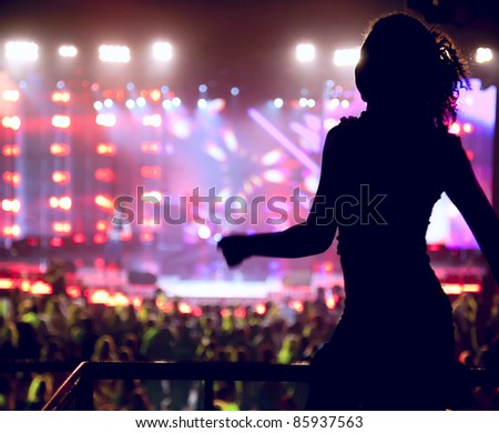 Dancing silhouette of woman in a nightclub