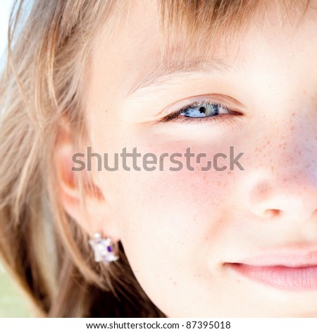 Portrait of attractive beautiful young girl with freckles and blue eyes