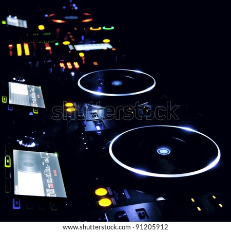 DJ CD player and mixer in nightclub