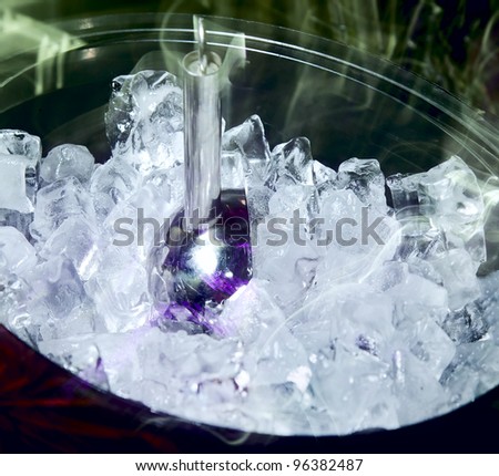 Ice for cooling drinks and cocktails in a large cup at the bar