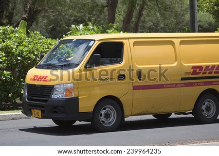 AVARUA, COOK ISLANDS - FEBRUARY 5, 2009: Delivery van of DHL on a road to Avarua. DHL is a division of Deutsche Post and offers international express mail services.