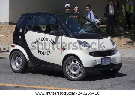 VANVOUVER, CANADA - AUGUST 6, 2005: Canadian Police car parking in front of tourists. The Police car is a two-seater car Smart, a fuel efficient compact car built by Daimler Benz.