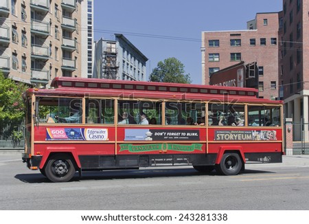 VANCOUVER, CANADA - AUGUST 6, 2005: Tour Trolley Bus driving on East Pender Street in Vancouver, Canada. Tourists enjoy a Vancouver Sightseeing Tour in a San Francisco-style Trolley.