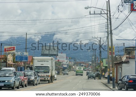 SAN JOSE, COSTA RICA - AUGUST 31, 2008: Traffic jam and parking cars on main street in San Jose, Costa Rica. San Jose is a modern city with bustling commerce and tourism industry.