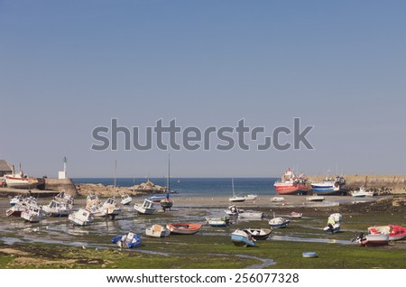 BARFLEUR, FRANCE - JULY 3, 2011: Fishing and recreational boats at low tide in the harbor of Barfleur. Barfleur is a picturesque fishing village in Basse Normandy.