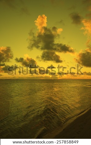 Sun setting behind Cumulus Clouds over Ocean and Island - Rarotonga, Cook Islands, Polynesia