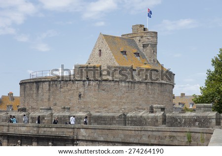 SAINT-MALO, FRANCE - JULY 6, 2011: Medieval castle built in 14th century with tourists in the old town of Saint-Malo, France. Saint-Malo is the main tourist attraction of Brittany in France.
