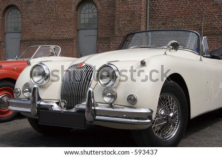 Vintage Jaguar - Convertible - a vision in white in front of a wall