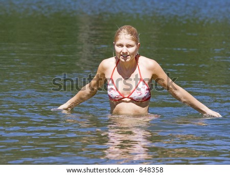 young woman in a lake after swimming - freezing - adobe RGB