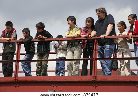 diverse family on a red bridge