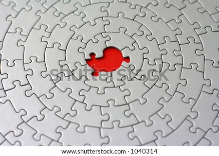 grey jigsaw with one missing piece - pieces fitting together in form of a spiral