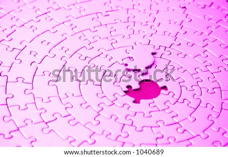 abstract of a pink jigsaw with the missing piece laying above the space - shallow DOF, focus is on the missing piece