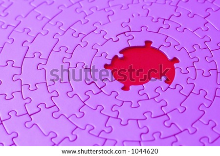 pink jigsaw with missing pieces in the center - shallow DOF, focus is on the big hole