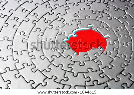 abstract of a silver jigsaw with missing pieces in the red center - shallow DOF, focus is on the big hole