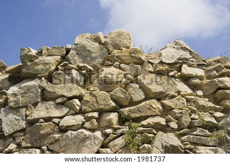 dry stone wall in and a summer sky - mediterranean architecture