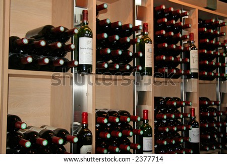 wine bottles in a rack - saint-emilion, france