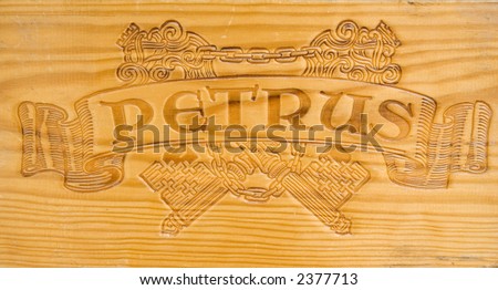 corporate logo of the famous winery chateau petrus - on a wooden wine box