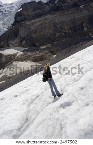 young woman walking on a glacier -  columbia icefield, jasper national park, canada