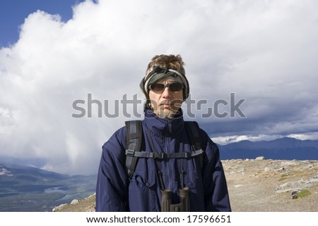 mountain hiker with backpack and sunglasses
