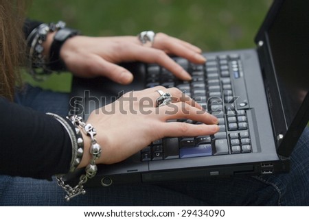 Female Hands typing on Laptop - close-up