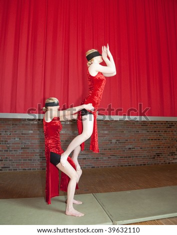 HERNE, GERMANY - MARCH 07: Children\'s Circus Bonboni presents an acrobatic act with the two blindfolded girls Anne Kunz, 14 and Diana Klein, 15 on March 07, 2009 in Herne, Germany.