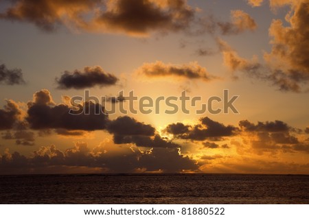 Sun setting behind dark Clouds over South Pacific Ocean - Rarotonga, Cook Islands, Polynesia
