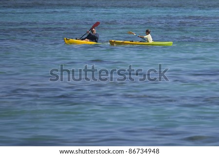 RAROTONGA, COOK ISLANDS - FEBRUARY 05: People sea kayaking in tropical lagoon of Rarotonga, Cook Islands on February 05, 2009. They train for the Cook Islands Cup in summer.
