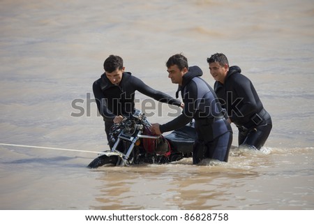 OLYMPOS, TURKEY - OCTOBER 14: Frogmen rescue a motorcycle after flood disaster on October 14, 2009 in Olympos, Turkey, Asia. The floods swept away about 50 cars and motor bikes.
