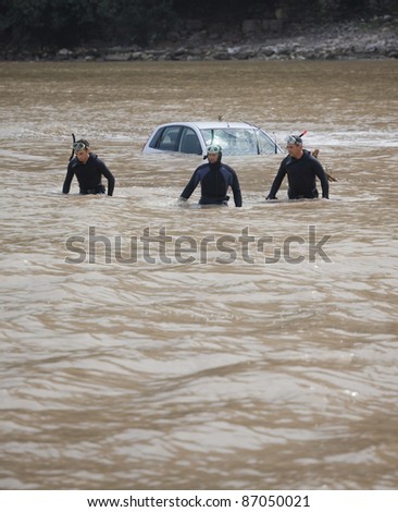 OLYMPOS, TURKEY - OCTOBER 14: Unidentified frogmen are at work rescuing victims after a flood on October 14, 2009 in Olympos, Turkey. The floods swept away about 50 cars and motor bikes.