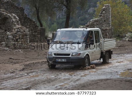 OLYMPOS, TURKEY - OCTOBER 14: Pick-Up Truck driving on muddy road after flood disaster on October 14, 2009 in Olympos, Turkey. The floods destroy roads and houses and swept away about 50 cars.