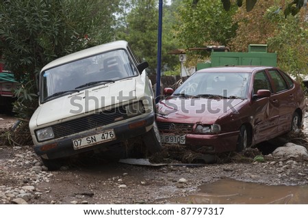 OLYMPOS, TURKEY - OCTOBER 14: Two crashed cars in the woods after flood disaster on October 14, 2009 in Olympos, Turkey, Asia. The floods destroy  roads and houses and swept away about 50 cars.