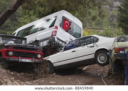 OLYMPOS, TURKEY - OCTOBER 14: Crashed cars in the woods after flood disaster on October 14, 2009 in Olympos, Turkey, Asia. The floods destroyed roads and houses and swept away about 50 cars.