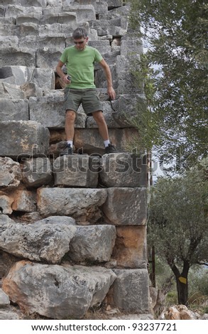 Mature Man moving down in ancient Amphitheater - Kas, Antalya Province, Turkey, Asia