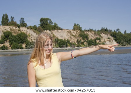 Young Woman pointing on the Beach - Saanichton, Vancouver Island, British Columbia, Canada