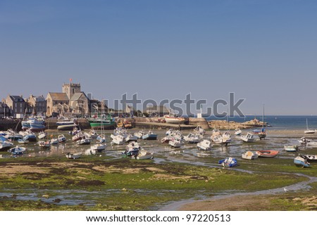 BARFLEUR, FRANCE - JULY 3: Fishing and recreational boats at low tide in the harbor of Barfleur, France on July 3, 2011. Barfleur is a picturesque fishing village in Basse Normandy.