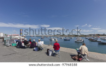 BARFLEUR, FRANCE - JULY 4: Group of artists painting the picturesque harbor of Barfleur, France on July 4, 2011. Barfleur is a fishing village in Basse Normandy.