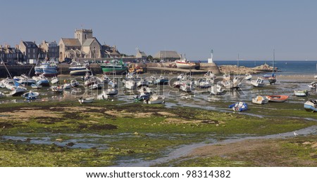 BARFLEUR, FRANCE - JULY 3: Fishing and recreational boats during low tide in the harbor of Barfleur, France on July 3, 2011. Barfleur is a picturesque fishing village in Basse Normandy.