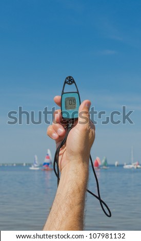 anemometer in the hand of man, which measures wind speed at sea