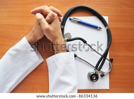 Hands of doctor with stetoscope and whipe paper