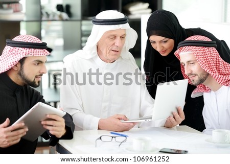 Business arabic people meeting indoor with electronic tablet