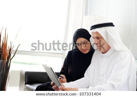 Muslim Arabic couple using Tablet computer