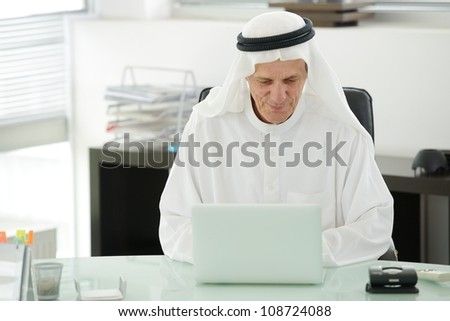 Portrait of a smart arabic business man using laptop