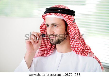 Portrait of a smart arabic business man using headset. Call center. Customer support. Helpdesk.