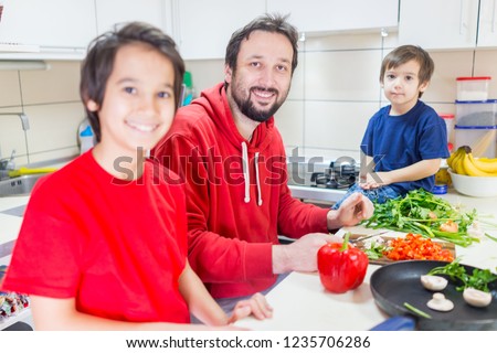 Father and his sons cooking
