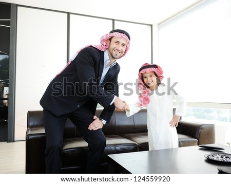 Arabic Muslim business people with children at office