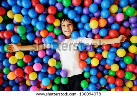 Little Smiling Boy Playing Lying In Colorful Balls Park Playground