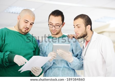 Teamwork of doctors working with tablet pc at hospital for discussion